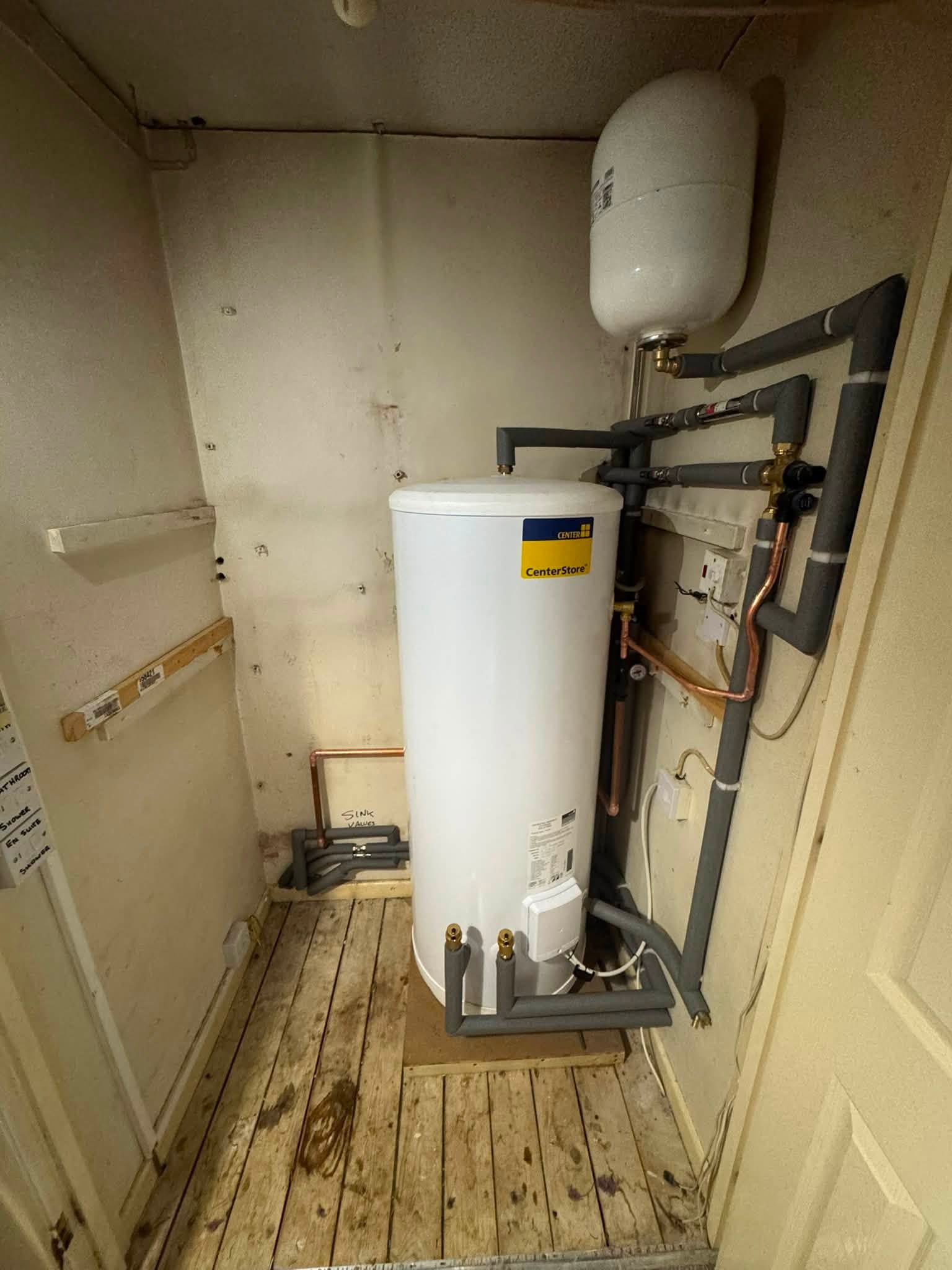 The finished cylinder installation from a second angle, with neatly lagged pipework