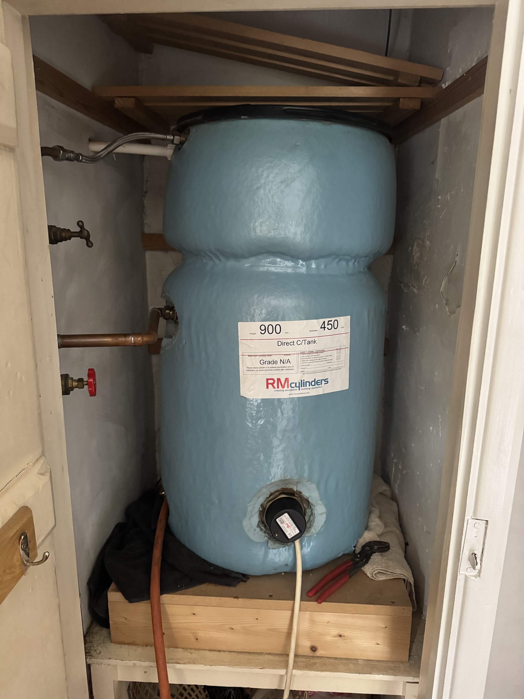 Insulated hot water cylinder in an airing cupboard