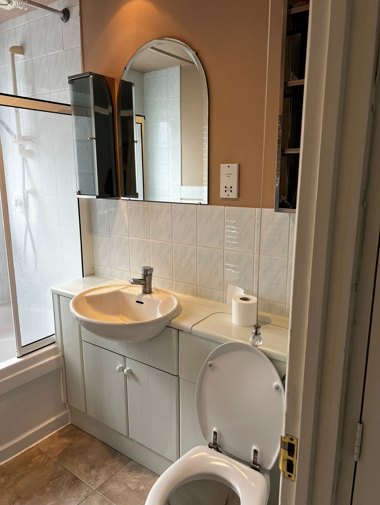 Bathroom with vanity basin unit, toilet and mirror cabinet