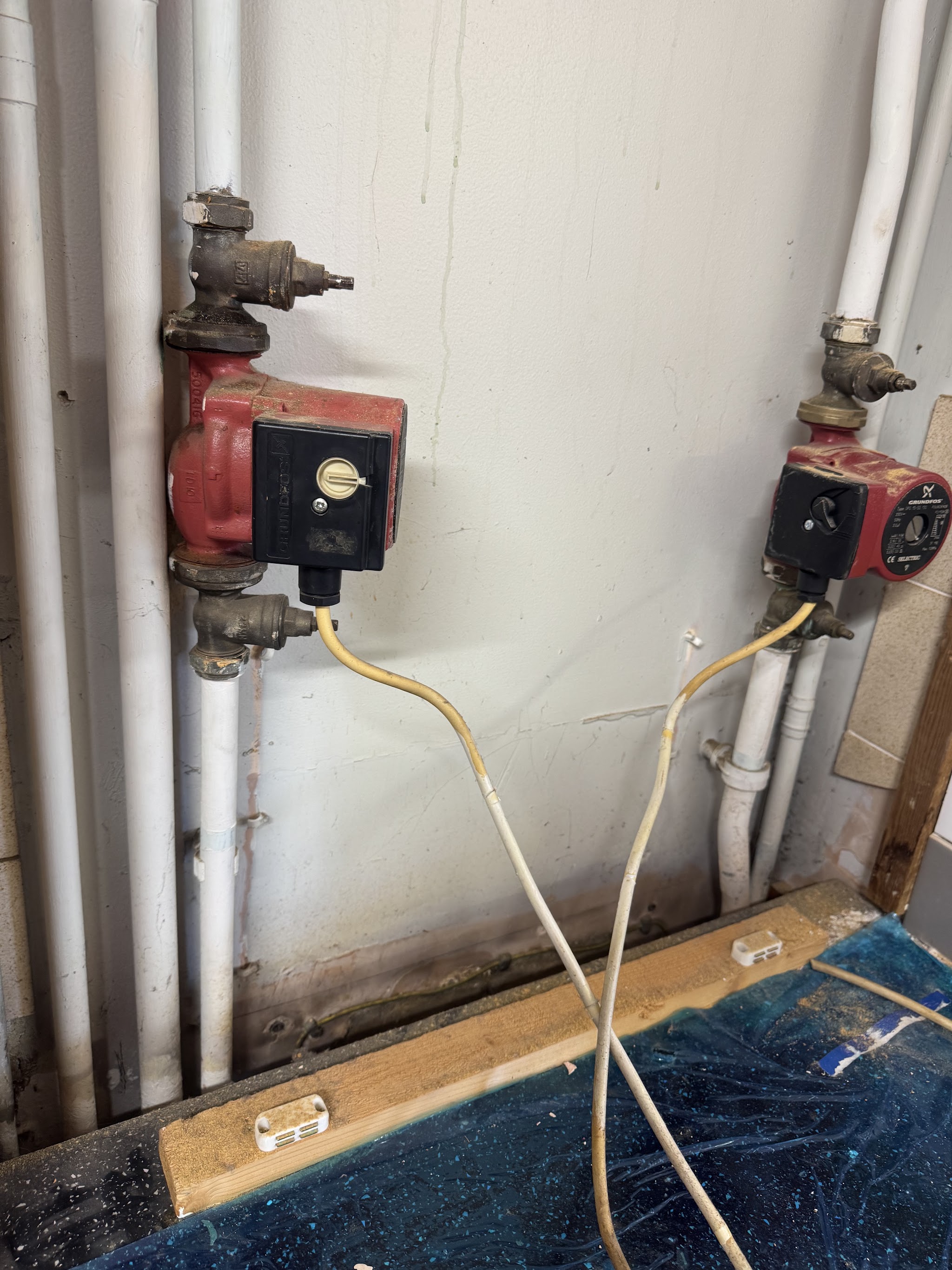 Two circulating pumps on the pipework of an older system